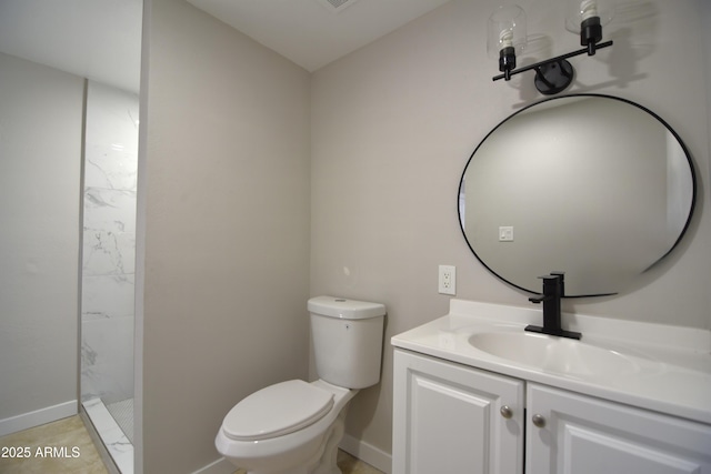 3640 W Garfield St, Phoenix, AZ 85009 - bathroom featuring toilet, vanity, walk in shower, and baseboards