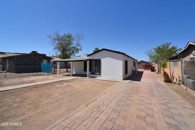 3640 W Garfield St, Phoenix, AZ 85009 - back of house featuring a fenced backyard, a patio, and stucco siding