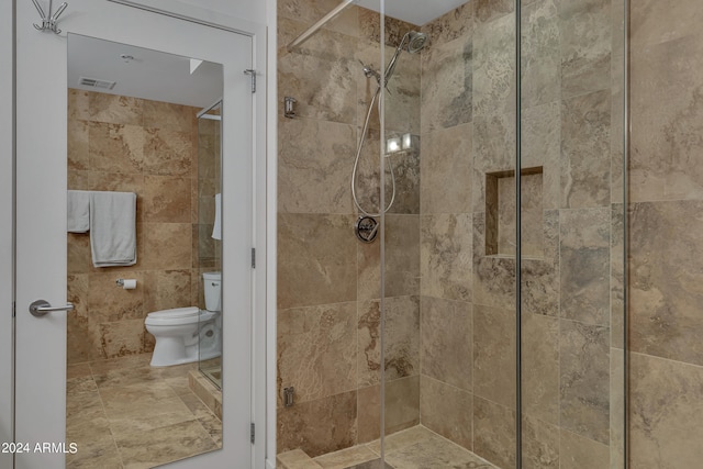 bathroom featuring toilet and an enclosed shower