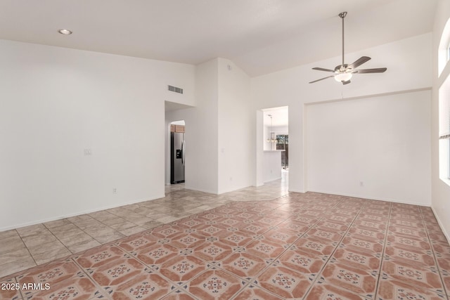 unfurnished room featuring tile patterned floors, high vaulted ceiling, a ceiling fan, baseboards, and visible vents