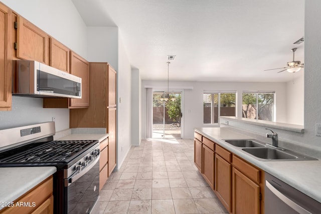 kitchen featuring light countertops, a sink, stainless steel appliances, visible vents, and ceiling fan