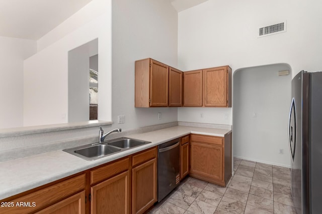 kitchen with light countertops, stainless steel appliances, marble finish floor, a sink, and visible vents