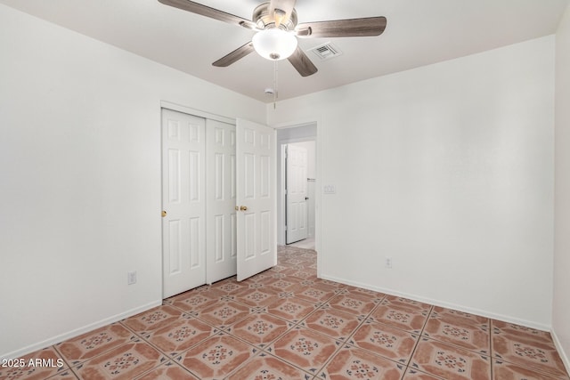 unfurnished bedroom with a closet, baseboards, visible vents, and a ceiling fan
