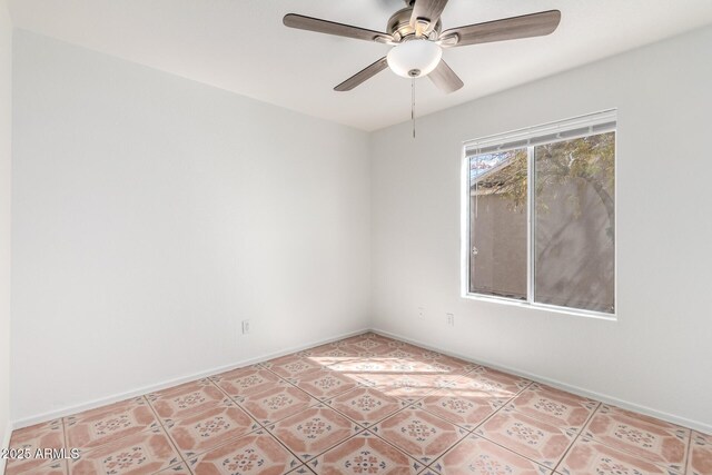 spare room with light tile patterned floors, baseboards, and ceiling fan