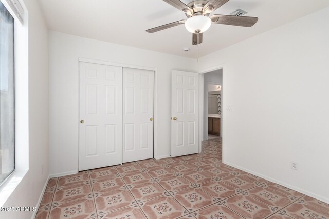 unfurnished bedroom featuring baseboards, visible vents, a closet, and ceiling fan