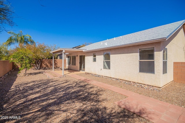 back of property with a fenced backyard, stucco siding, and a patio
