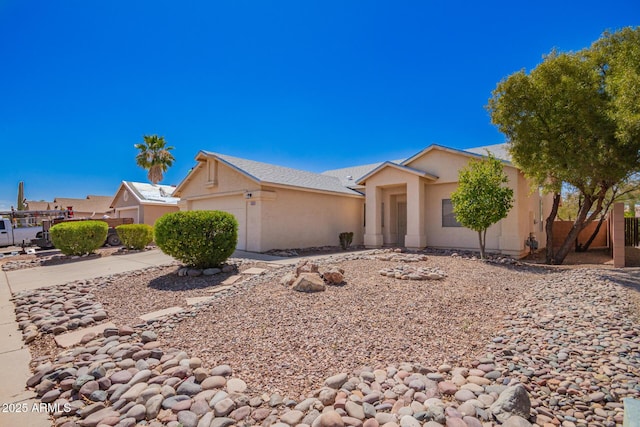 view of front of home featuring fence, stucco siding, and a garage