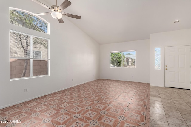 interior space with light tile patterned floors, high vaulted ceiling, baseboards, and ceiling fan