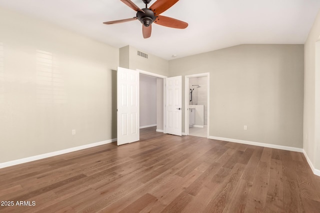 unfurnished bedroom featuring connected bathroom, wood finished floors, visible vents, and baseboards