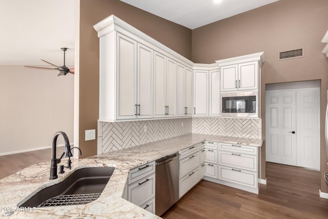 kitchen featuring ceiling fan, light stone counters, a sink, visible vents, and appliances with stainless steel finishes