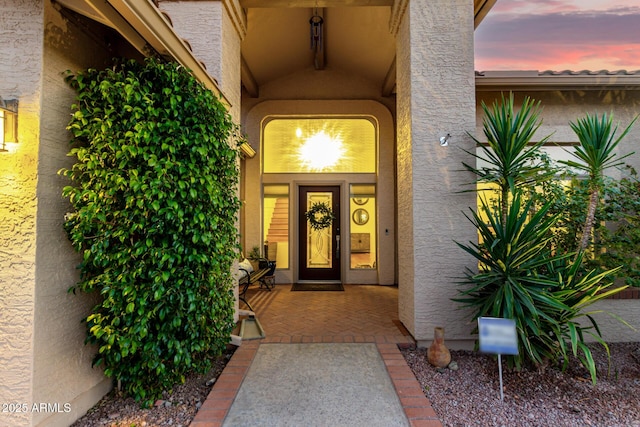 view of exterior entry at dusk