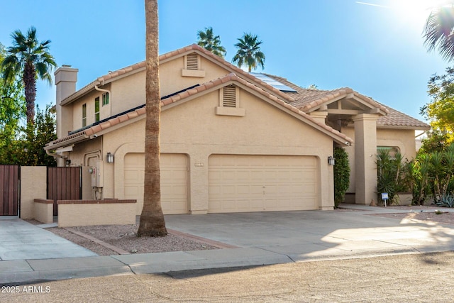 view of front of property featuring a garage and solar panels