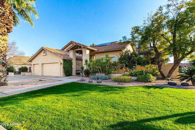 mediterranean / spanish-style house with a garage, a front yard, and solar panels