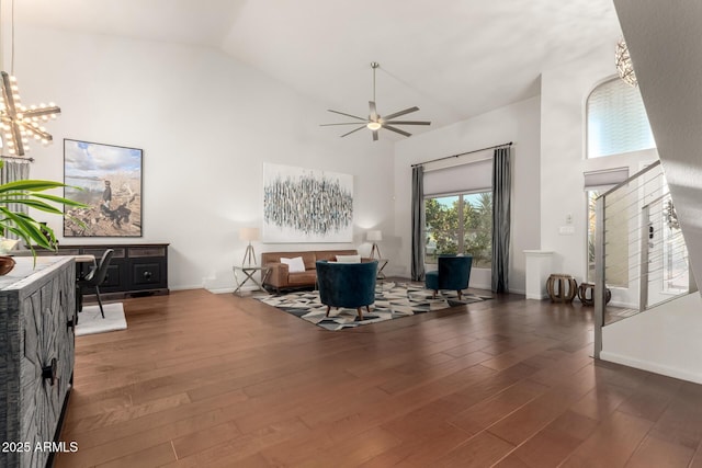 office space with dark hardwood / wood-style floors, ceiling fan with notable chandelier, and high vaulted ceiling