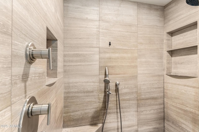 bathroom with a tile shower