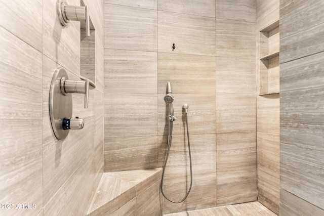 bathroom with a tile shower