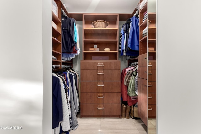 walk in closet with light tile patterned flooring