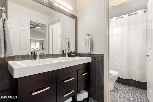 bathroom with toilet, a shower with curtain, tile walls, vanity, and tile patterned flooring