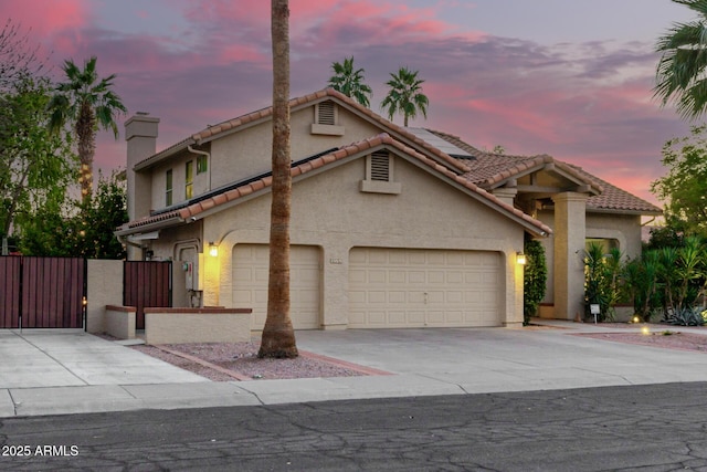 mediterranean / spanish-style house with a garage