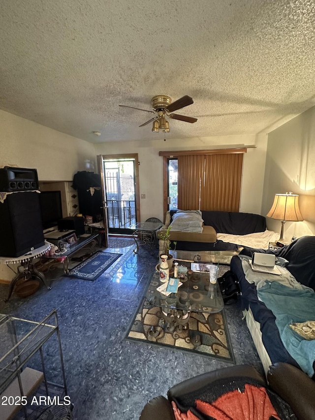 living room featuring a textured ceiling and ceiling fan