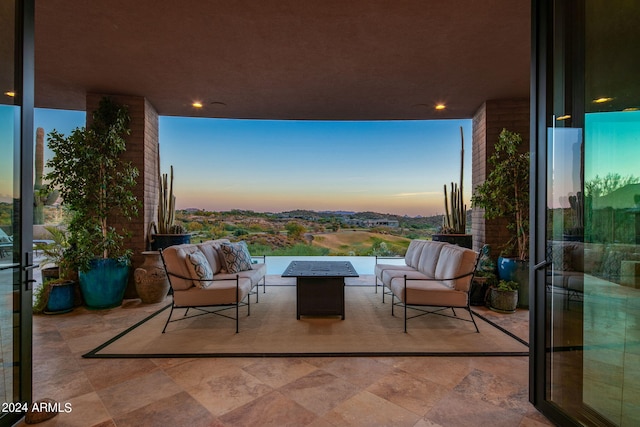 patio terrace at dusk featuring an outdoor hangout area