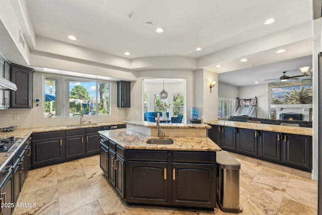 7214 E Royal Palm Rd, Scottsdale, AZ 85258 - kitchen with a sink, a kitchen island with sink, recessed lighting, and healthy amount of natural light