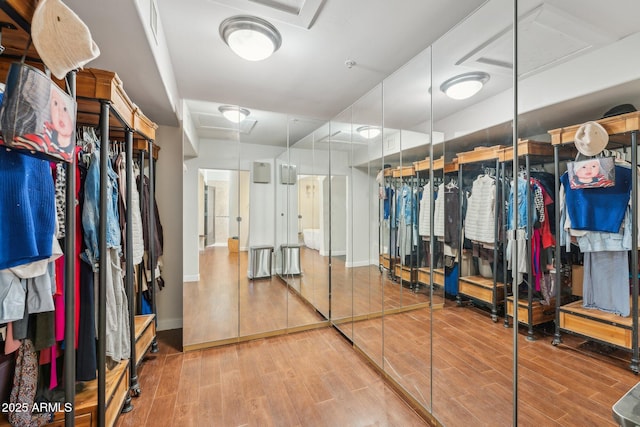 7214 E Royal Palm Rd, Scottsdale, AZ 85258 - spacious closet featuring wood finished floors and attic access