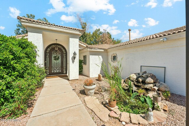 7214 E Royal Palm Rd, Scottsdale, AZ 85258 - view of exterior entry featuring a tile roof and stucco siding
