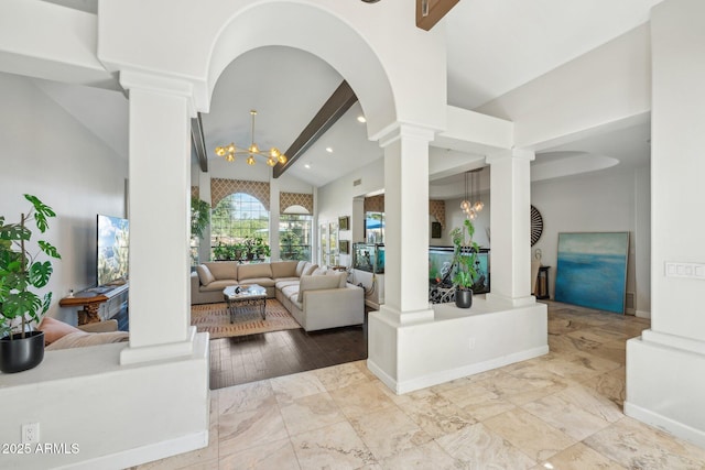 7214 E Royal Palm Rd, Scottsdale, AZ 85258 - living area with decorative columns, a chandelier, arched walkways, and baseboards
