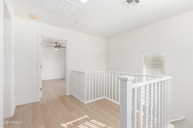 corridor with light hardwood / wood-style floors