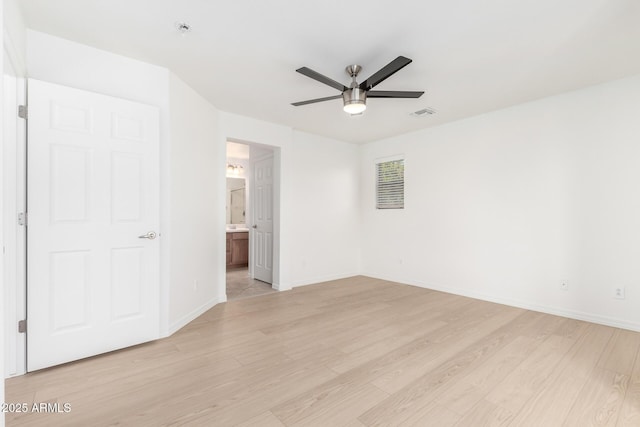 unfurnished bedroom with ceiling fan, ensuite bath, and light hardwood / wood-style flooring