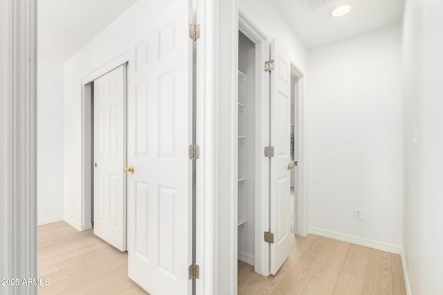 hallway with light hardwood / wood-style flooring