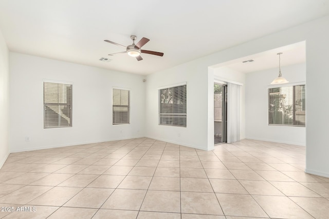 empty room featuring light tile patterned floors and ceiling fan