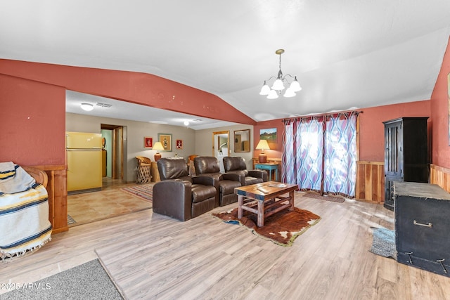 living room with visible vents, vaulted ceiling, a chandelier, and light wood-style floors