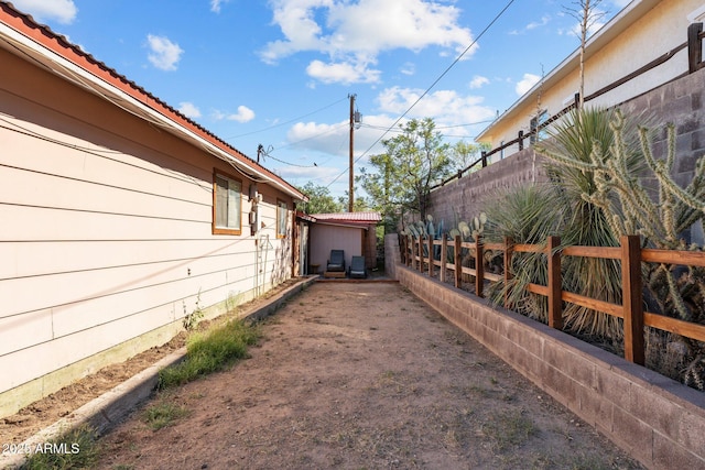 view of side of home with fence