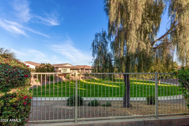 view of gate with a yard