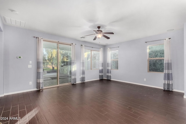 empty room with ceiling fan and dark wood-type flooring