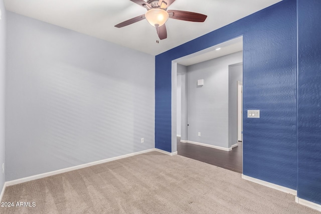 carpeted spare room with ceiling fan