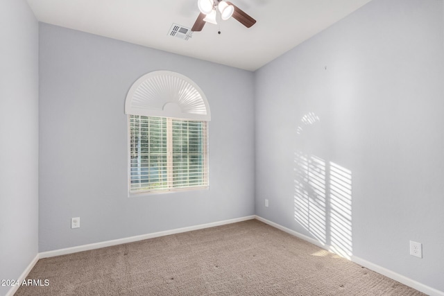 spare room with carpet and ceiling fan