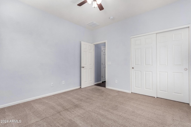 unfurnished bedroom featuring carpet flooring, ceiling fan, and a closet