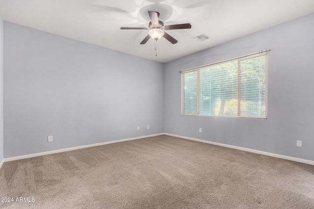 empty room featuring ceiling fan and carpet floors