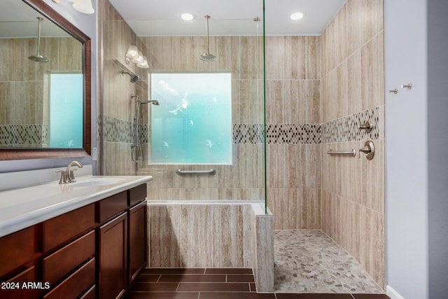 bathroom with vanity and tiled shower