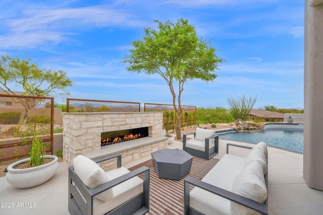 view of patio featuring an outdoor living space with a fireplace and a fenced in pool