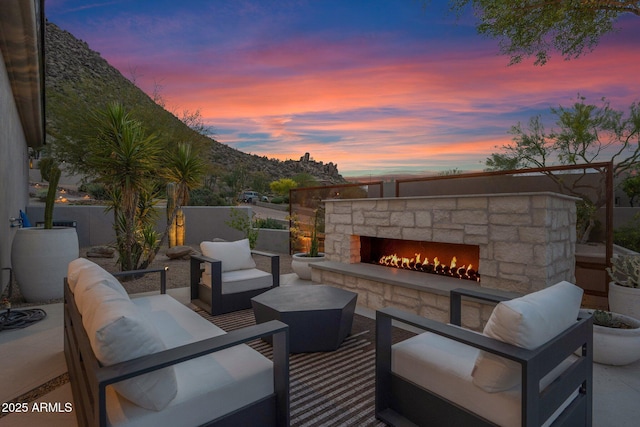 view of patio / terrace with an outdoor living space with a fireplace