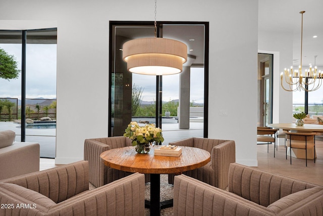 dining area with a notable chandelier and wood finished floors