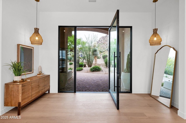 entryway with baseboards and light wood-type flooring