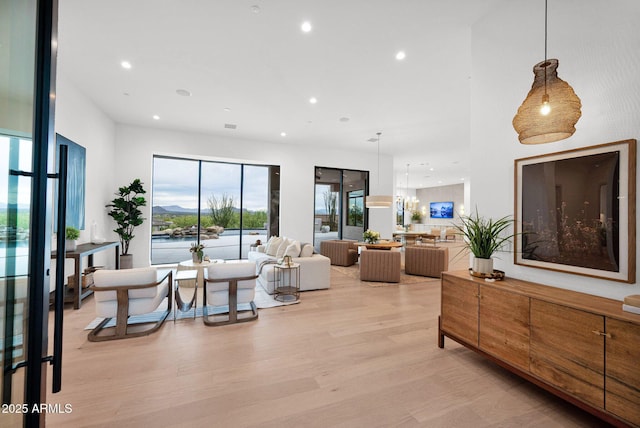 living area featuring light wood-style floors and recessed lighting
