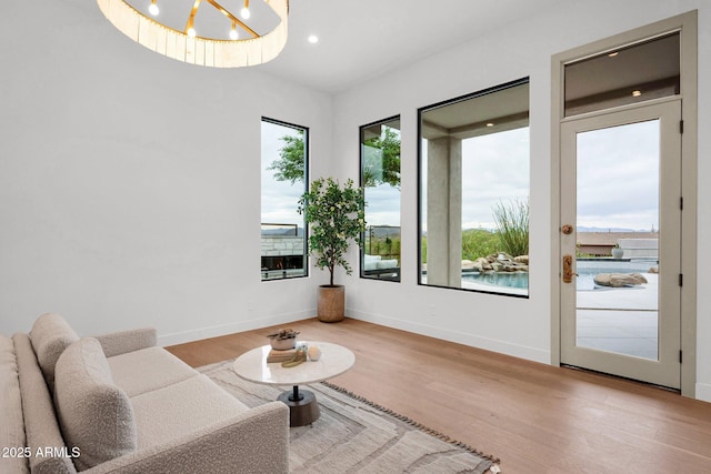 living area featuring baseboards, recessed lighting, and wood finished floors