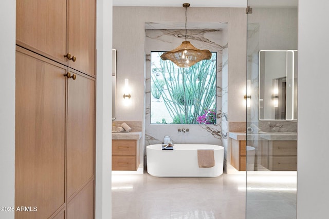 full bath featuring a freestanding tub and vanity