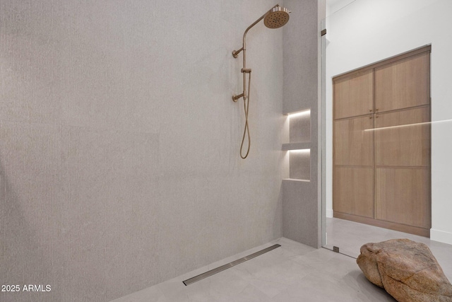 bathroom with a tile shower